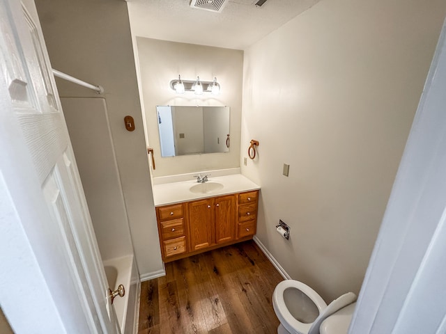 6132 E Forsee Rd, Ashland, MO 65010 - full bathroom with toilet, wood finished floors, visible vents, baseboards, and vanity