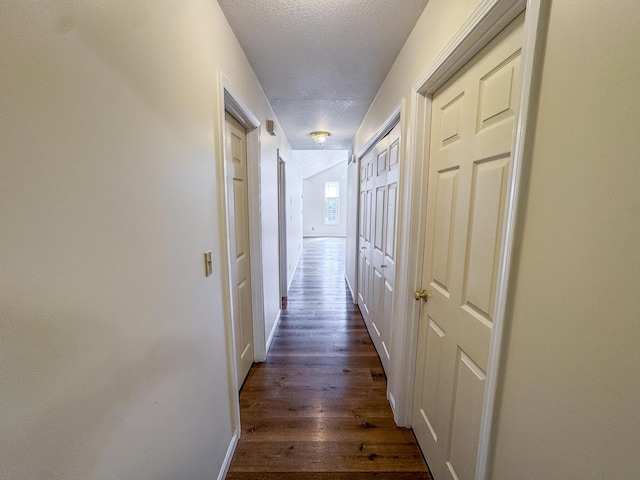 6132 E Forsee Rd, Ashland, MO 65010 - hallway featuring a textured ceiling, baseboards, and dark wood finished floors