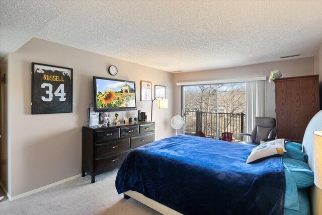 bedroom with light colored carpet, visible vents, baseboards, and a textured ceiling