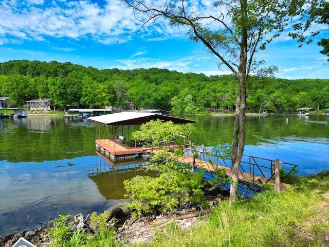 27206 Lakeside Ln, Barnett, MO 65011 - dock area featuring a wooded view and a water view