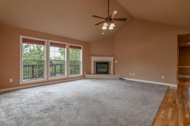 606 Billy Joe Sapp Dr, Ashland, MO 65010 - unfurnished living room featuring lofted ceiling, a ceiling fan, a tile fireplace, wood finished floors, and baseboards