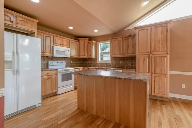 606 Billy Joe Sapp Dr, Ashland, MO 65010 - kitchen featuring white appliances, light wood-style floors, decorative backsplash, a center island, and lofted ceiling