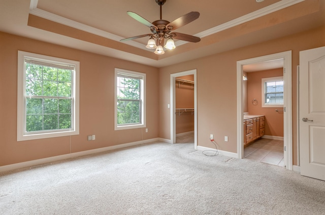 606 Billy Joe Sapp Dr, Ashland, MO 65010 - unfurnished bedroom with crown molding, light carpet, multiple windows, a tray ceiling, and a spacious closet