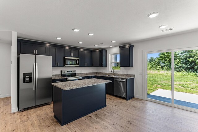 35 Andy Ct, Clark, MO 65243 - kitchen featuring appliances with stainless steel finishes, light stone countertops, light wood-style floors, a center island, and recessed lighting