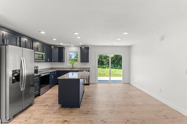 35 Andy Ct, Clark, MO 65243 - kitchen with stainless steel appliances, light stone counters, light wood finished floors, a kitchen island, and recessed lighting