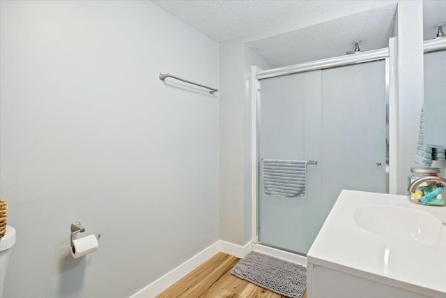 28489 Possum Trot Rd, Stover, MO 65078 - bathroom with toilet, baseboards, a shower stall, a textured ceiling, and wood finished floors