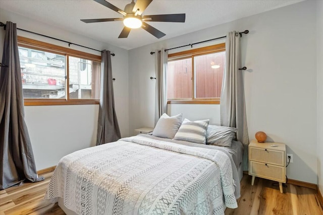 28489 Possum Trot Rd, Stover, MO 65078 - bedroom with a ceiling fan, baseboards, and wood finished floors