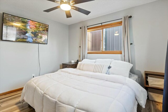 28489 Possum Trot Rd, Stover, MO 65078 - bedroom featuring baseboards, wood finished floors, and ceiling fan