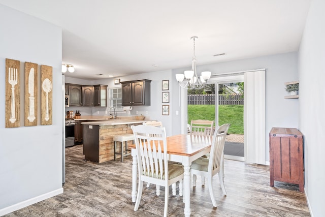dining space featuring baseboards, an inviting chandelier, and visible vents