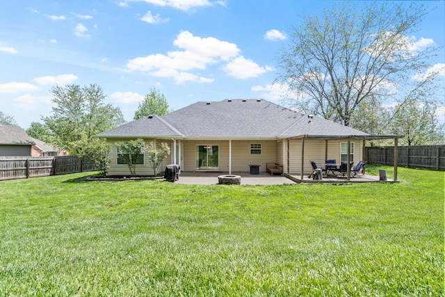 back of property with a fenced backyard, a patio, a lawn, and an outdoor fire pit