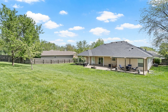 back of house featuring a fenced backyard, a patio, and a yard