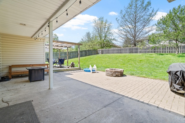view of patio with central AC unit, a fenced backyard, and an outdoor fire pit