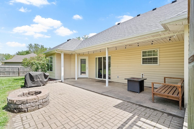 view of patio / terrace with a fire pit, fence, and area for grilling