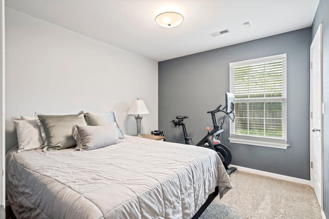 carpeted bedroom with visible vents and baseboards