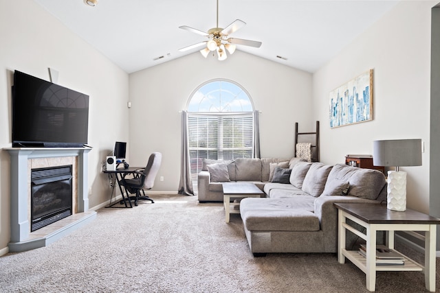 carpeted living room featuring a tiled fireplace, a ceiling fan, baseboards, lofted ceiling, and visible vents