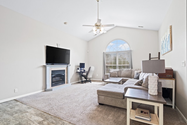 living room with carpet, ceiling fan, vaulted ceiling, and a fireplace