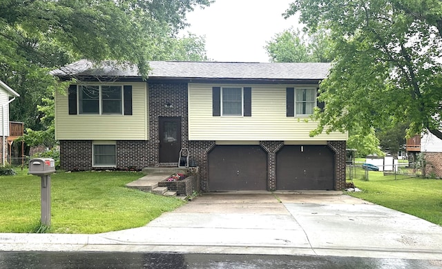 5501 S Brooks Dr, Jefferson City, MO 65109 - raised ranch featuring an attached garage, brick siding, and concrete driveway
