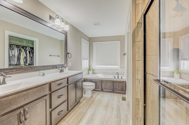 4716 Emeribrook Ct, Columbia, MO 65203 - bathroom featuring double vanity, a bath, visible vents, and a sink