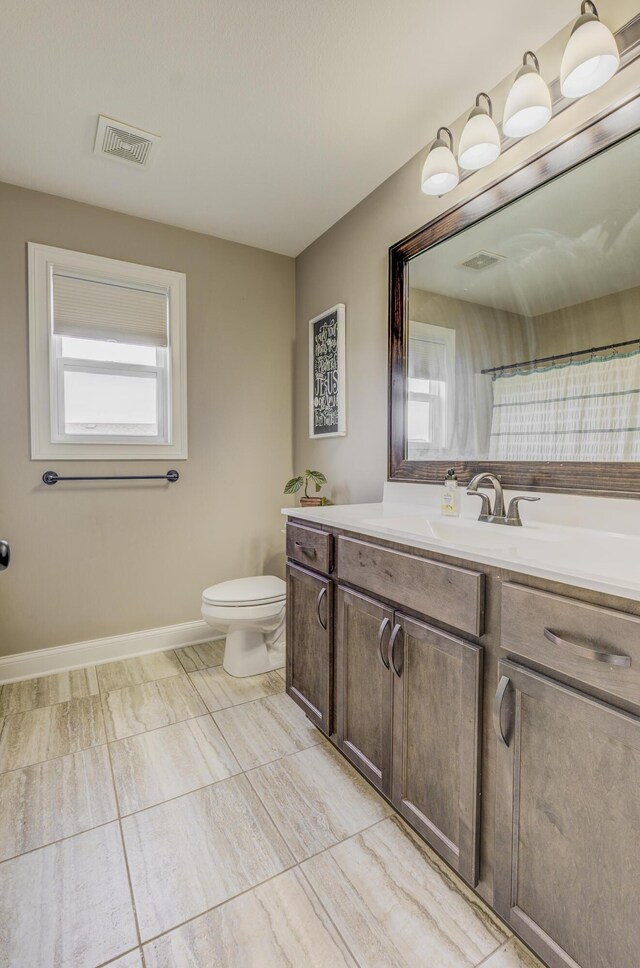 4716 Emeribrook Ct, Columbia, MO 65203 - bathroom with toilet, vanity, baseboards, and visible vents