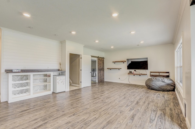 4716 Emeribrook Ct, Columbia, MO 65203 - living area with baseboards, a barn door, ornamental molding, recessed lighting, and wood finished floors