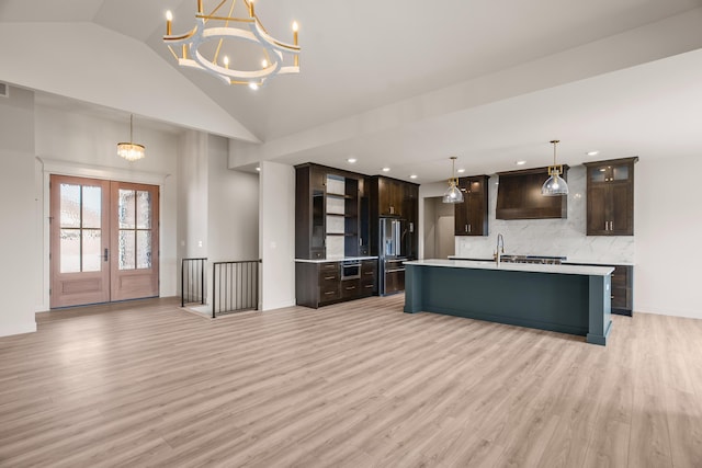 kitchen featuring open shelves, dark brown cabinetry, light wood-style floors, light countertops, and high end refrigerator