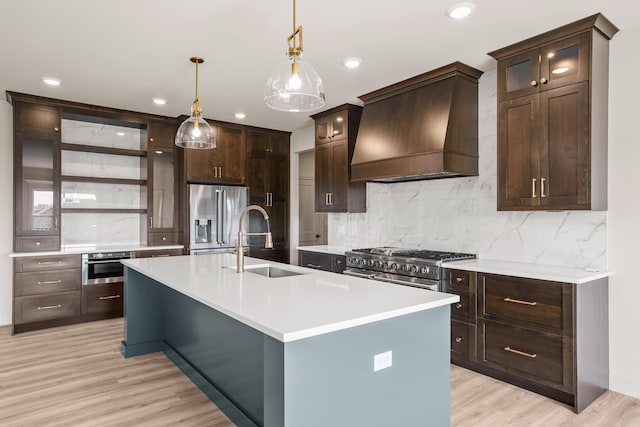 kitchen featuring backsplash, a sink, light countertops, custom exhaust hood, and stainless steel appliances