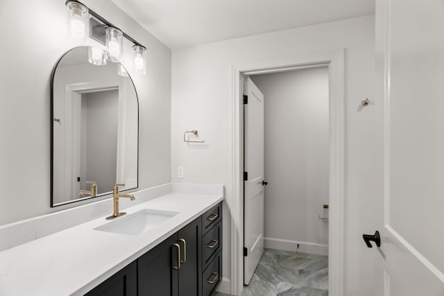 bathroom featuring marble finish floor and vanity