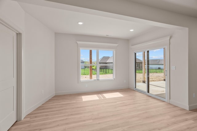 interior space with light wood-style floors, recessed lighting, and baseboards