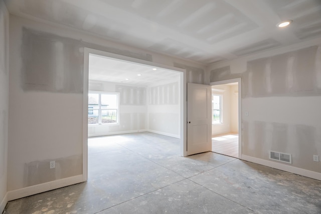 empty room featuring visible vents, recessed lighting, baseboards, and a wealth of natural light