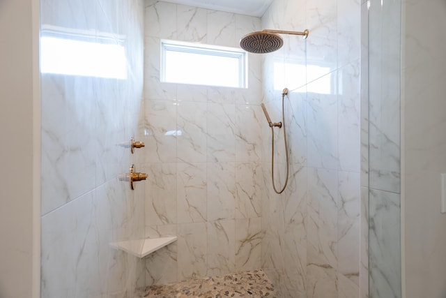 full bathroom featuring a marble finish shower