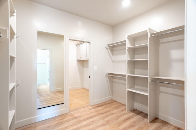 spacious closet featuring light wood-style flooring