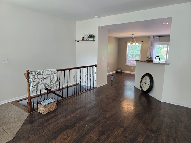 5003 Chesapeake Ln, Columbia, MO 65202 - empty room featuring wood finished floors, baseboards, a chandelier, and a sink