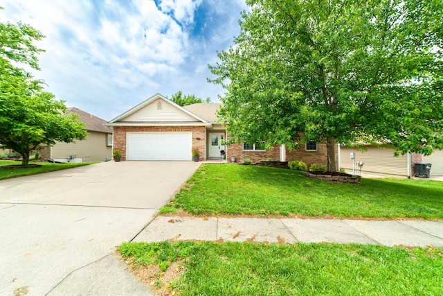 5003 Chesapeake Ln, Columbia, MO 65202 - view of front of house with a garage, brick siding, driveway, and a front lawn