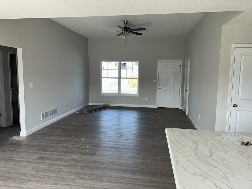 2312 Bitternut Ct, Columbia, MO 65201 - unfurnished living room featuring ceiling fan, baseboards, and wood finished floors