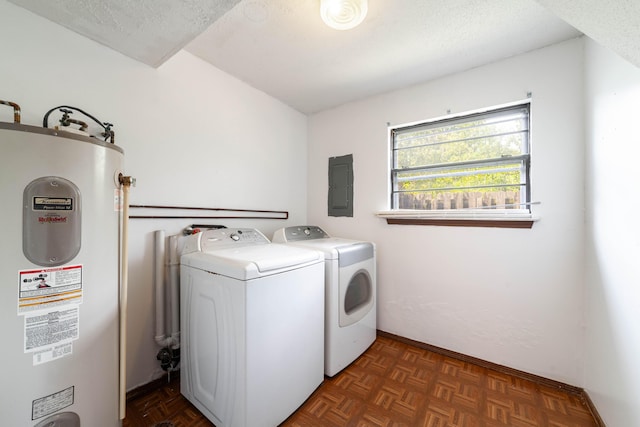 laundry room featuring a textured ceiling, electric panel, laundry area, water heater, and washing machine and dryer