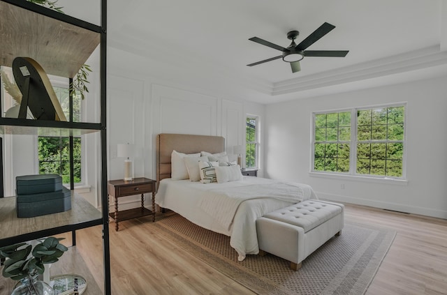 9747 S Rte N, Columbia, MO 65203 - bedroom featuring a raised ceiling, light wood-type flooring, and ceiling fan