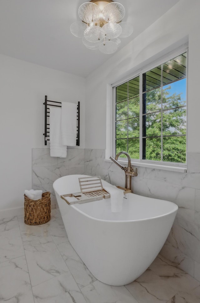 9747 S Rte N, Columbia, MO 65203 - full bath featuring tile walls, a towel warming rack, marble finish flooring, a freestanding bath, and a chandelier