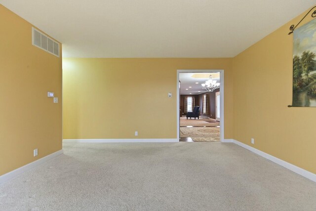 1204 S Walnut Ave, Salisbury, MO 65281 - carpeted spare room with a notable chandelier, visible vents, and baseboards