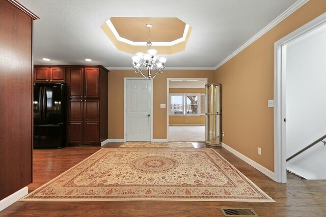 1204 S Walnut Ave, Salisbury, MO 65281 - unfurnished dining area featuring crown molding, baseboards, an inviting chandelier, and dark wood-type flooring