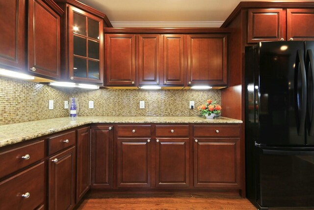 1204 S Walnut Ave, Salisbury, MO 65281 - kitchen with backsplash, glass insert cabinets, freestanding refrigerator, and reddish brown cabinets