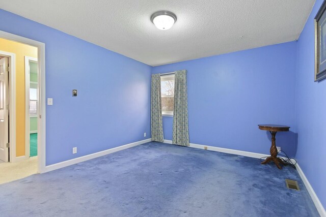 1204 S Walnut Ave, Salisbury, MO 65281 - carpeted spare room featuring visible vents, a textured ceiling, and baseboards