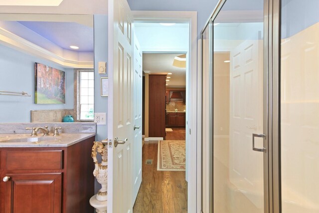 1204 S Walnut Ave, Salisbury, MO 65281 - bathroom with a shower stall, wood finished floors, vanity, and backsplash
