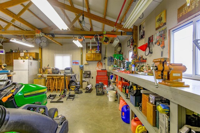 1204 S Walnut Ave, Salisbury, MO 65281 - garage featuring freestanding refrigerator and a workshop area
