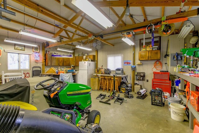 1204 S Walnut Ave, Salisbury, MO 65281 - garage featuring freestanding refrigerator and a workshop area
