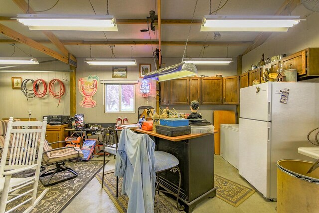 1204 S Walnut Ave, Salisbury, MO 65281 - kitchen featuring brown cabinetry, finished concrete floors, and freestanding refrigerator
