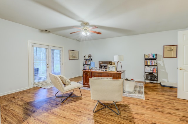 office space with baseboards, light wood finished floors, ceiling fan, and visible vents