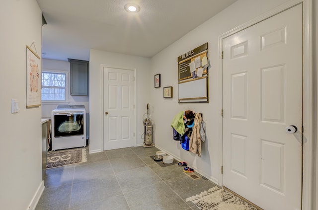 laundry room featuring washer / clothes dryer, baseboards, and cabinet space