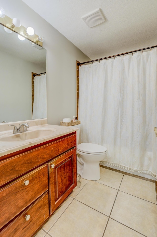 full bathroom featuring visible vents, toilet, tile patterned flooring, and vanity