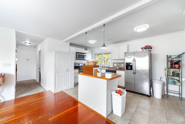 509 S Bus-54, Fulton, MO 65251 - kitchen featuring a center island, decorative light fixtures, light countertops, white cabinets, and appliances with stainless steel finishes