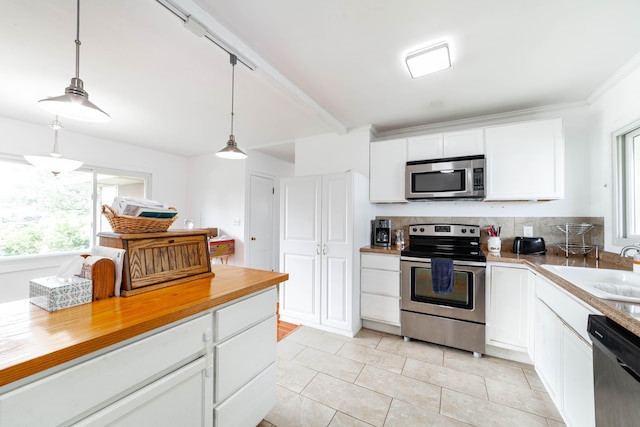 509 S Bus-54, Fulton, MO 65251 - kitchen featuring white cabinets, appliances with stainless steel finishes, light tile patterned floors, and a sink